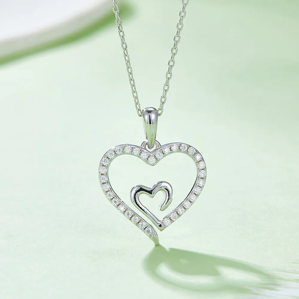 Heart-shaped pendant necklace with diamonds on a light green background