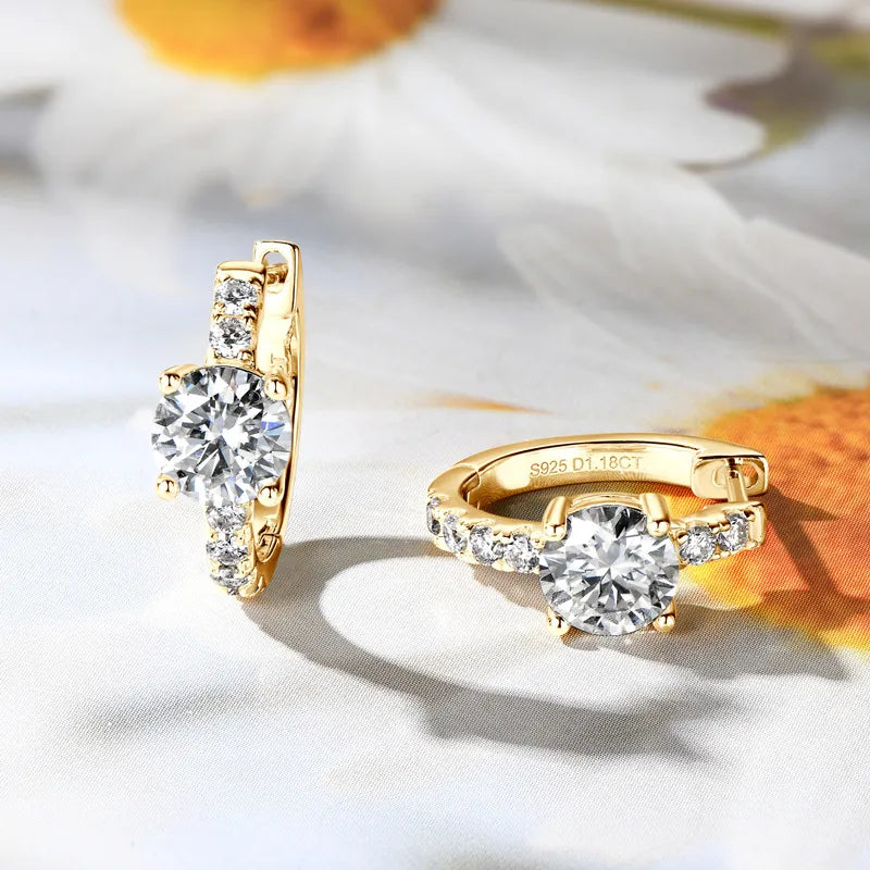 Gold ring and earrings on a white background with floral elements
