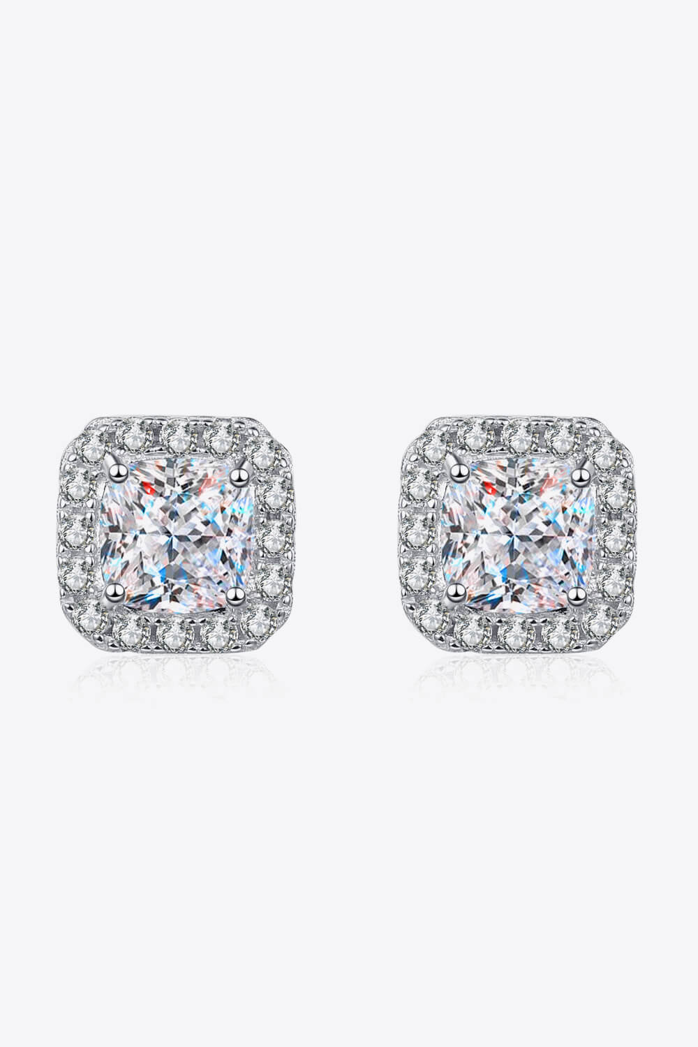 Pair of square-shaped earrings with clear gemstones on a white background