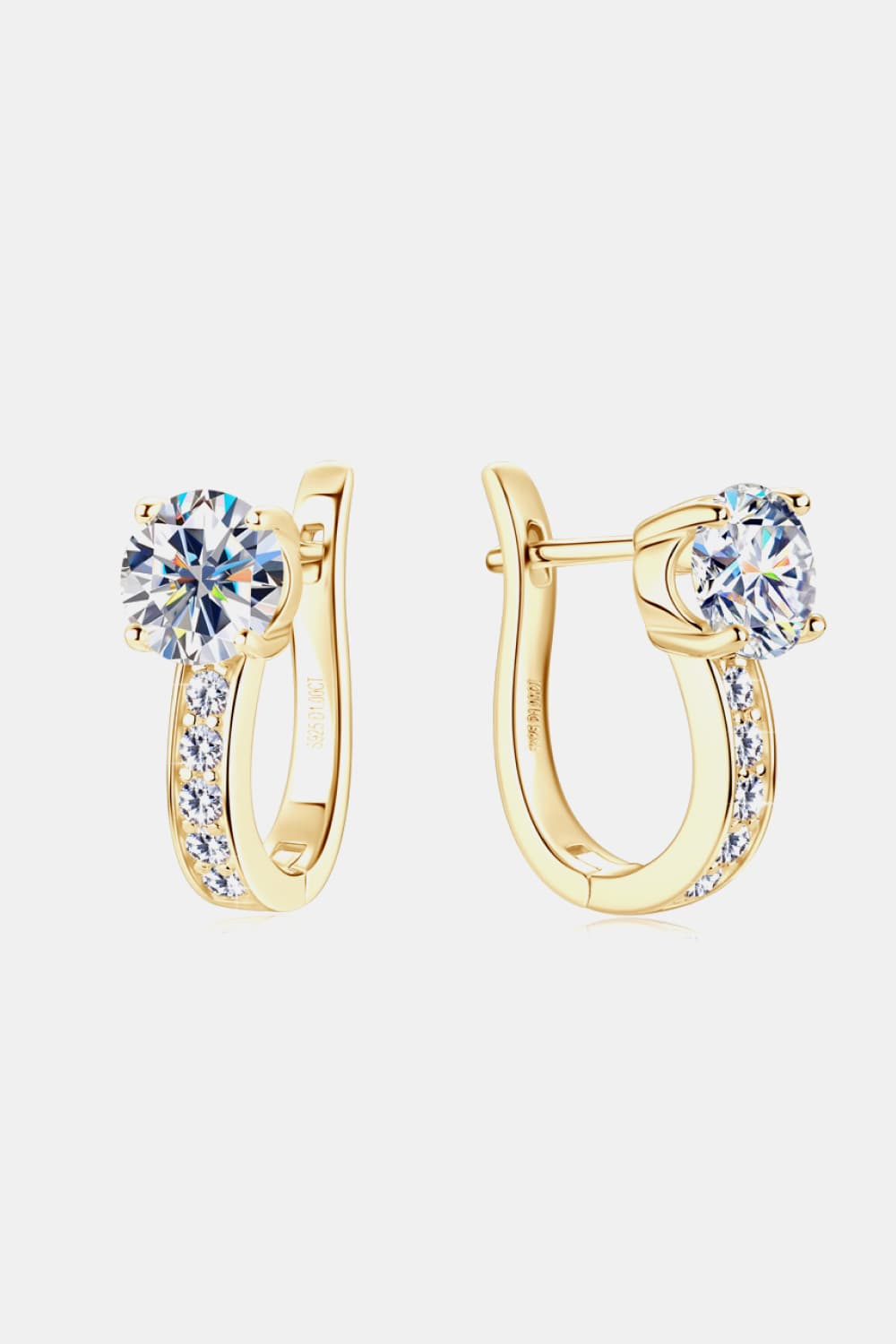 Gold hoop earrings with clear gemstones on a white background