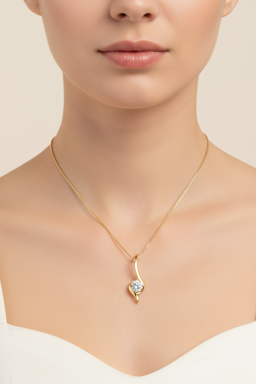 Gold pendant with a diamond on a white background