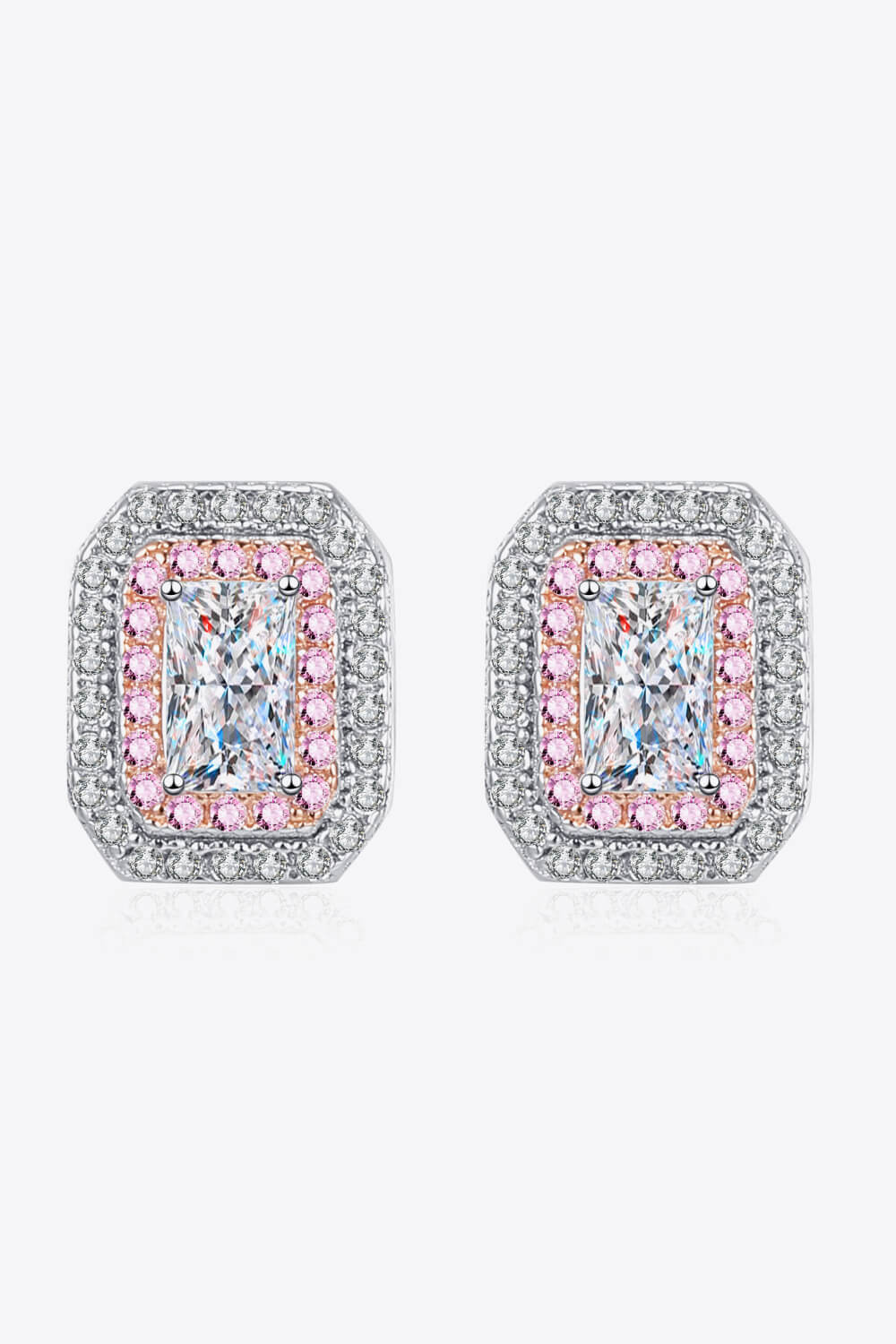 Pair of earrings with pink and clear gemstones on a white background