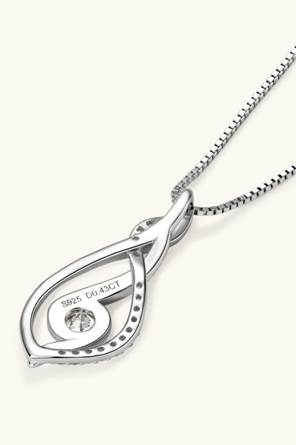 Silver pendant necklace with a diamond on a white background