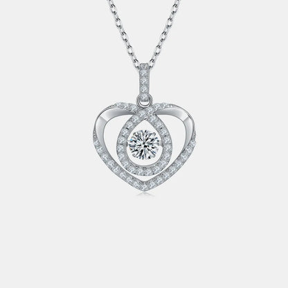 Heart-shaped silver pendant with a central round gemstone on a light gray background
