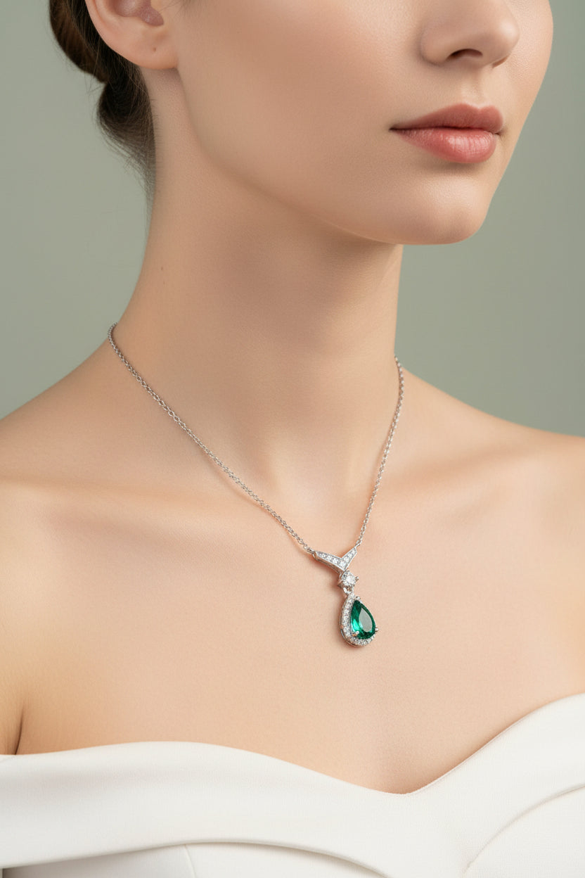 Necklace with a green pendant worn by a model on a neutral background