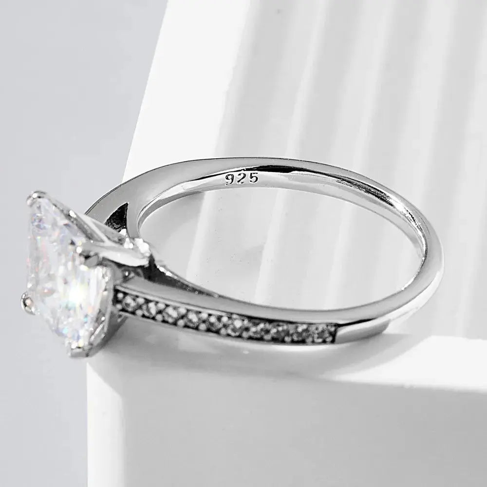 Silver ring with a large diamond on a white background