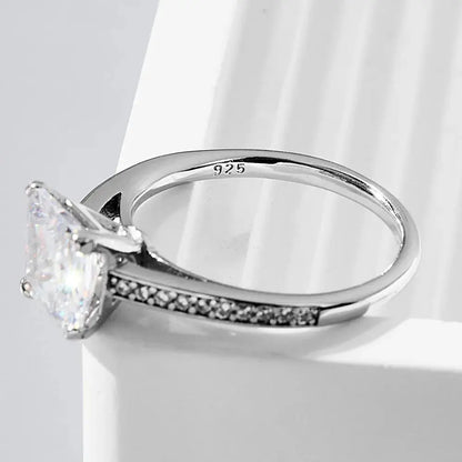 Silver ring with a large diamond on a white background