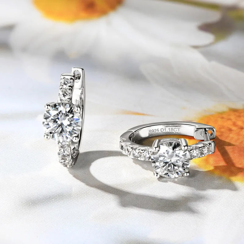 Silver ring and earring set on a white background with floral elements