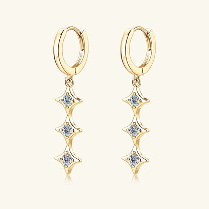 Gold hoop earrings with star-shaped diamond drops on a white background