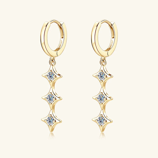 Gold hoop earrings with star-shaped diamond drops on a white background