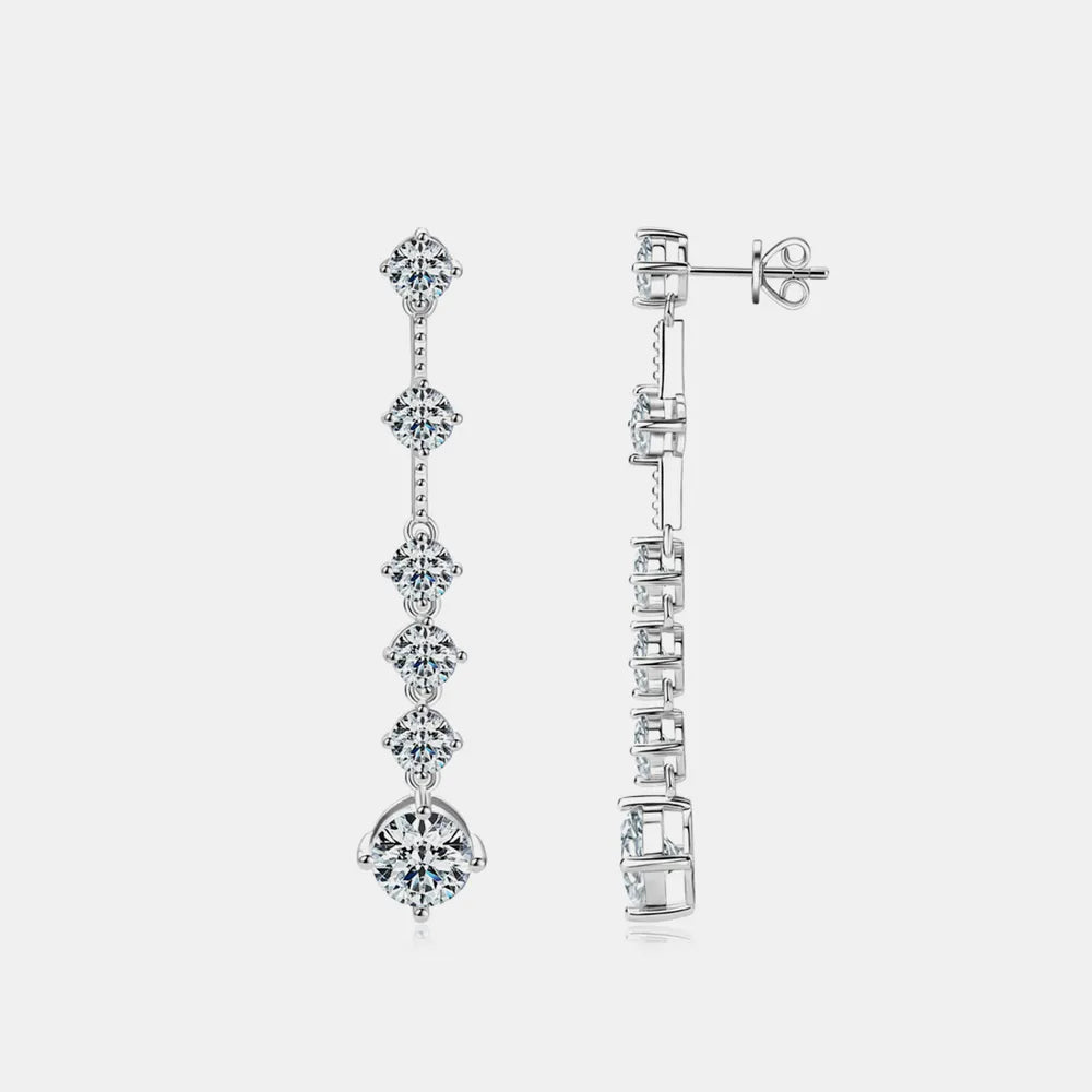 Pair of silver earrings with diamond-like stones on a white background