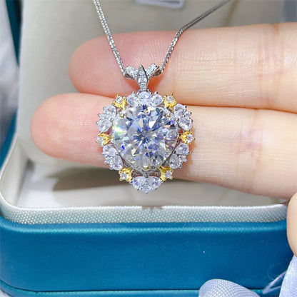 Diamond necklace held between fingers with a blue box in the background