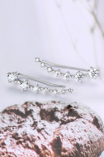 Silver hair pins with clear crystals on a textured surface