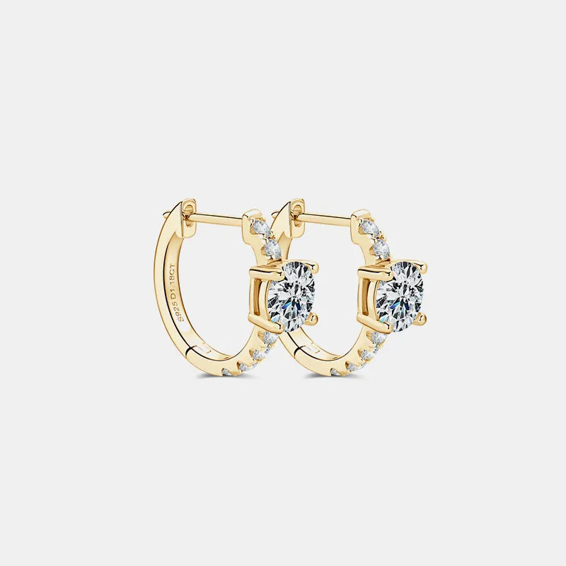Gold hoop earrings with diamond accents on a light gray background
