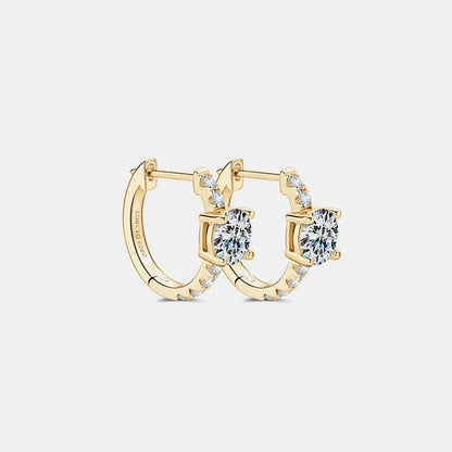 Gold hoop earrings with diamond accents on a light gray background