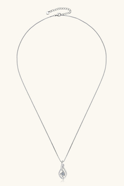 Silver necklace with a teardrop pendant on a white background