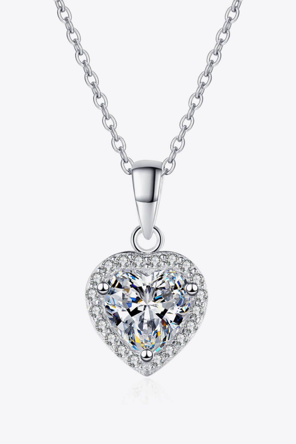 Heart-shaped diamond pendant on a white background