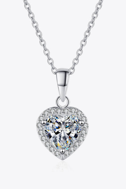 Heart-shaped diamond pendant on a white background
