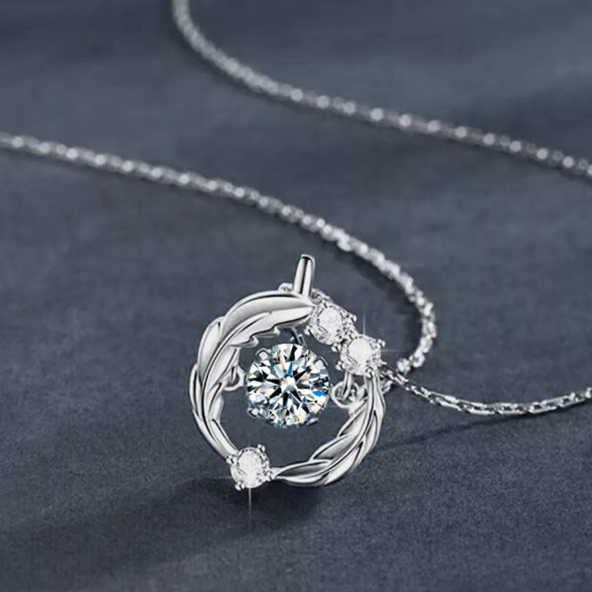 Silver necklace with a circular pendant featuring a central gemstone on a dark gray background