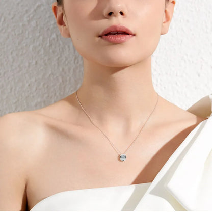 Necklace with a pendant worn by a person against a neutral background