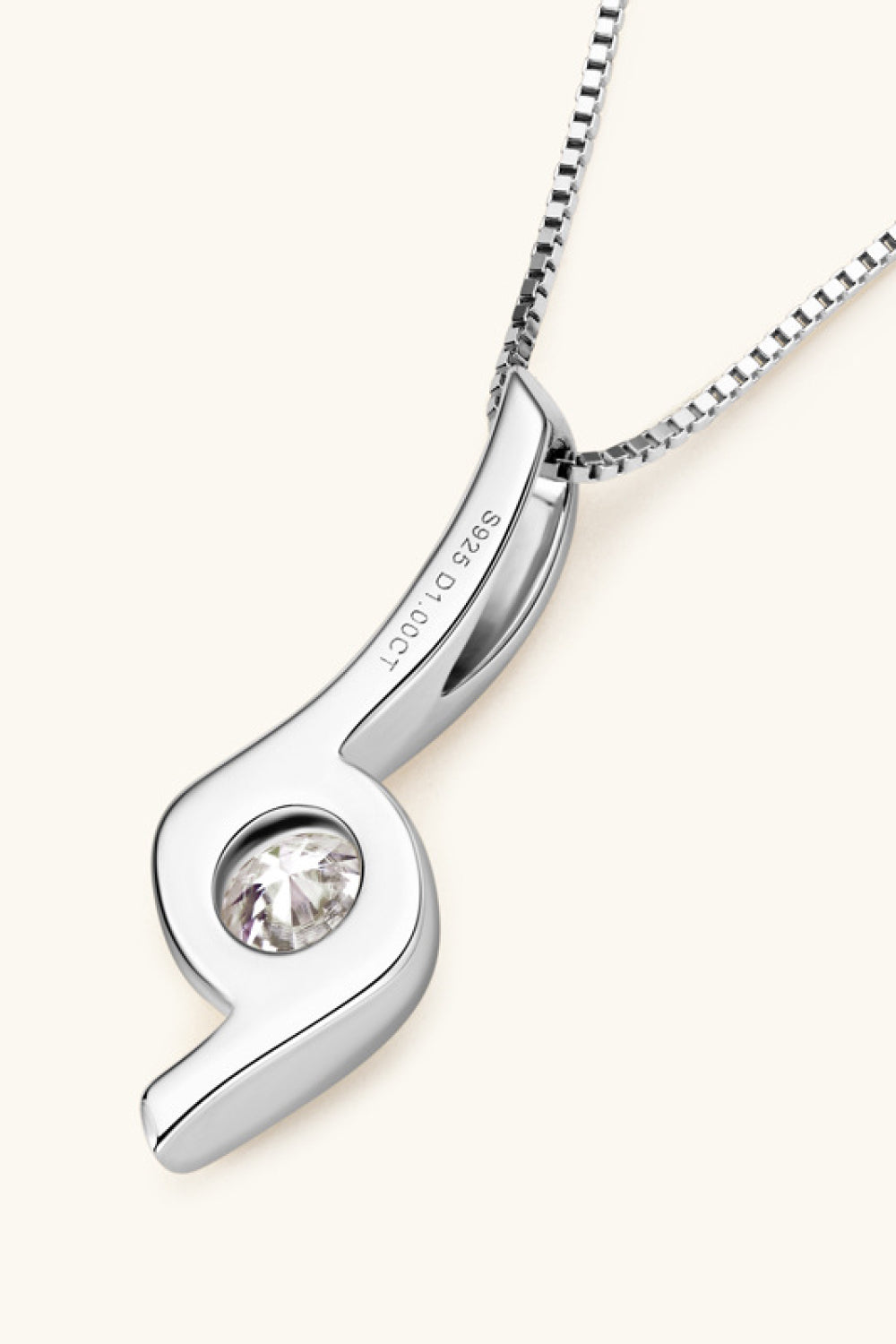 Silver pendant with a clear gemstone on a white background