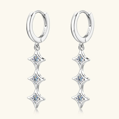 Silver hoop earrings with star-shaped dangling elements on a white background