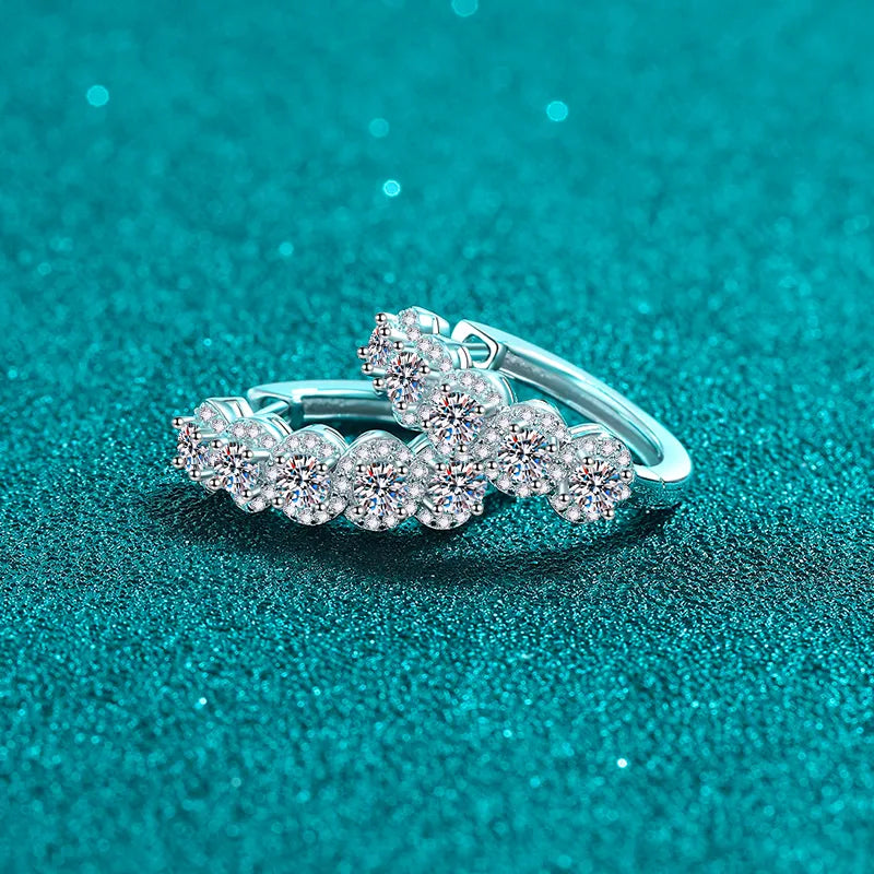 Silver ring with gemstones on a teal glittery background
