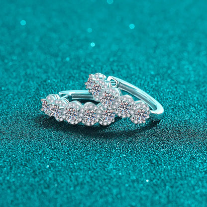 Silver ring with gemstones on a teal glittery background