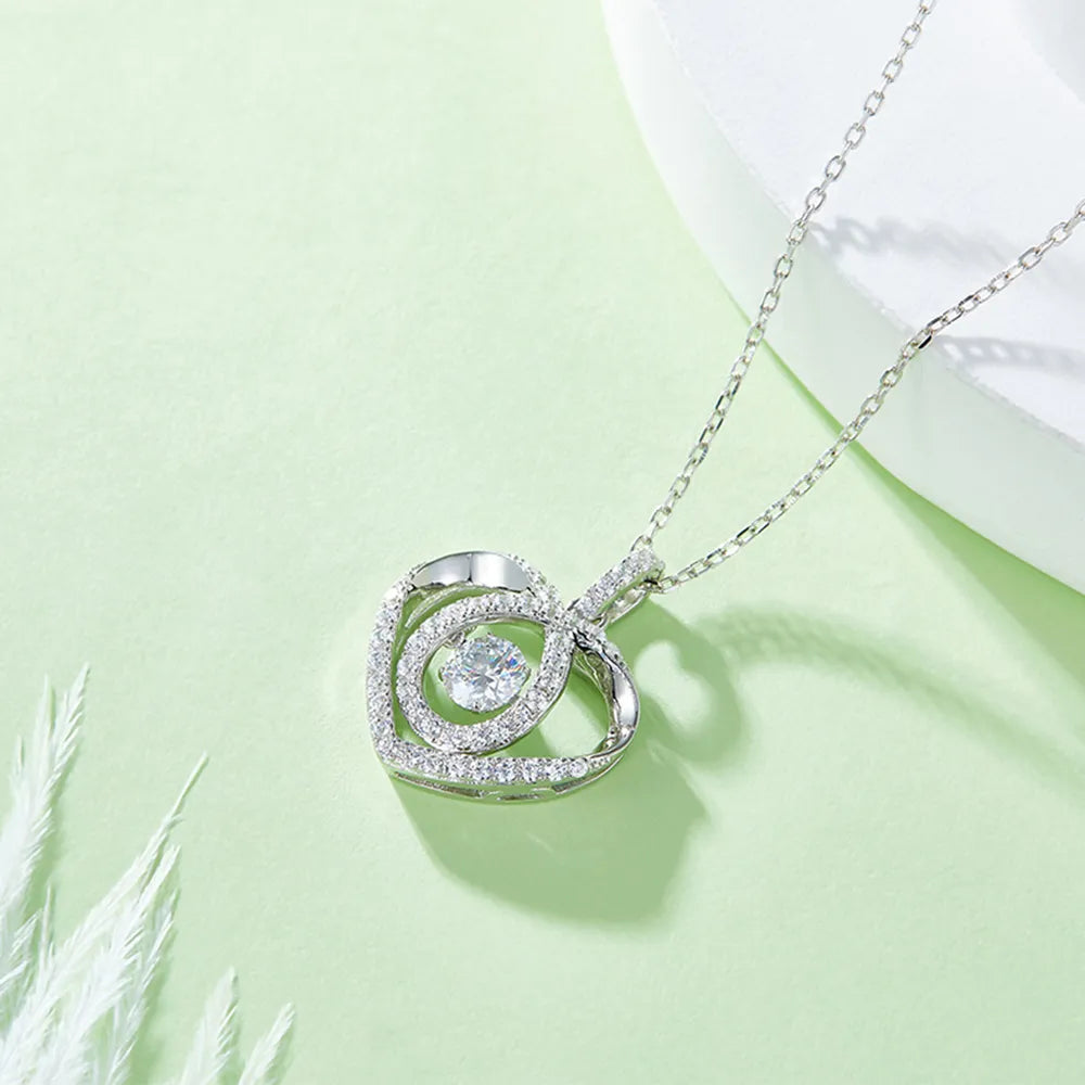 Silver necklace with a circular pendant on a light green background