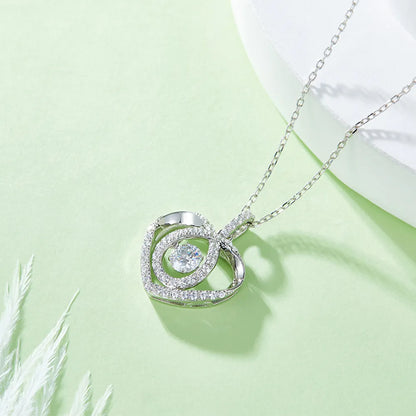 Silver necklace with a circular pendant on a light green background