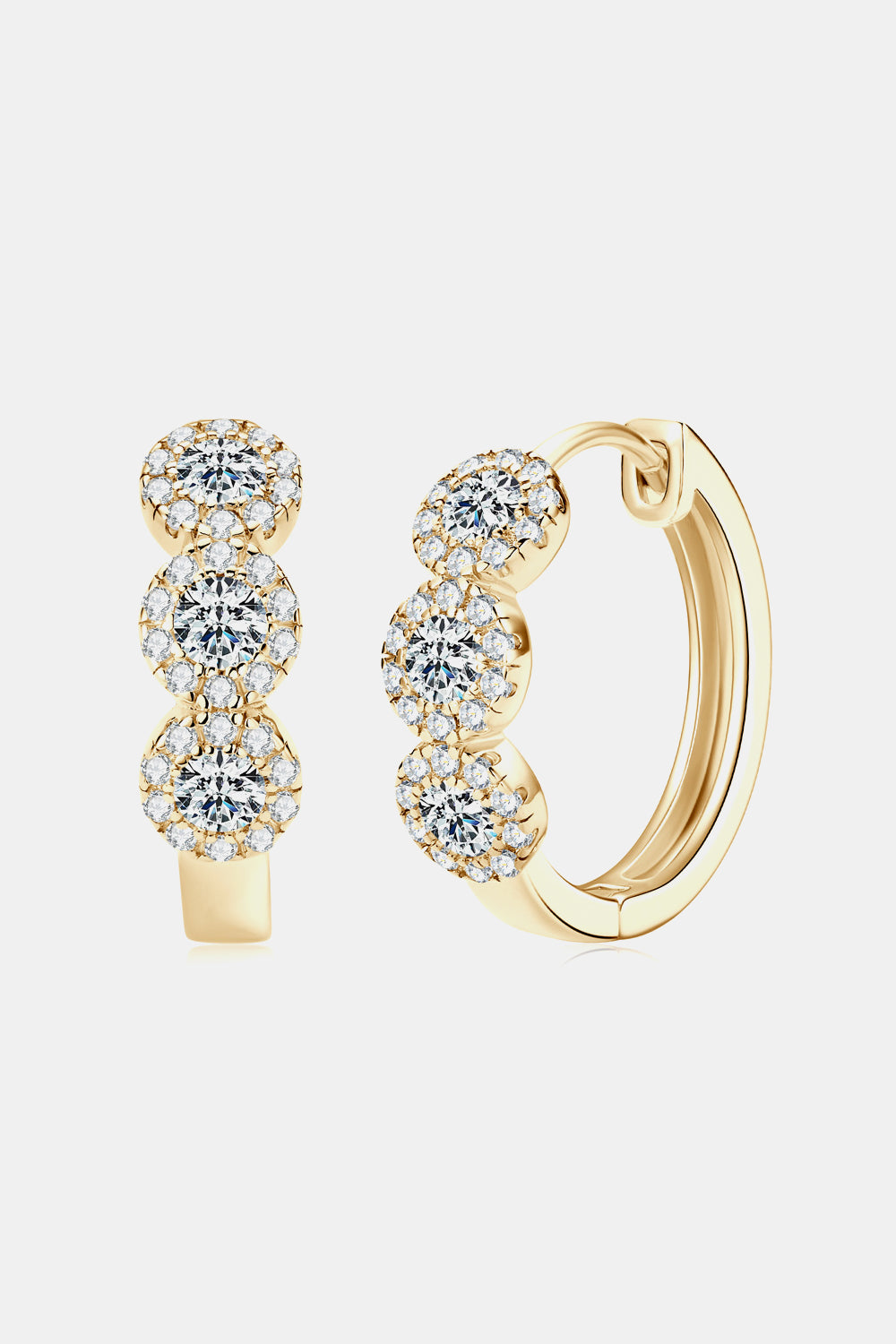 Gold hoop earrings with diamond-like stones on a white background