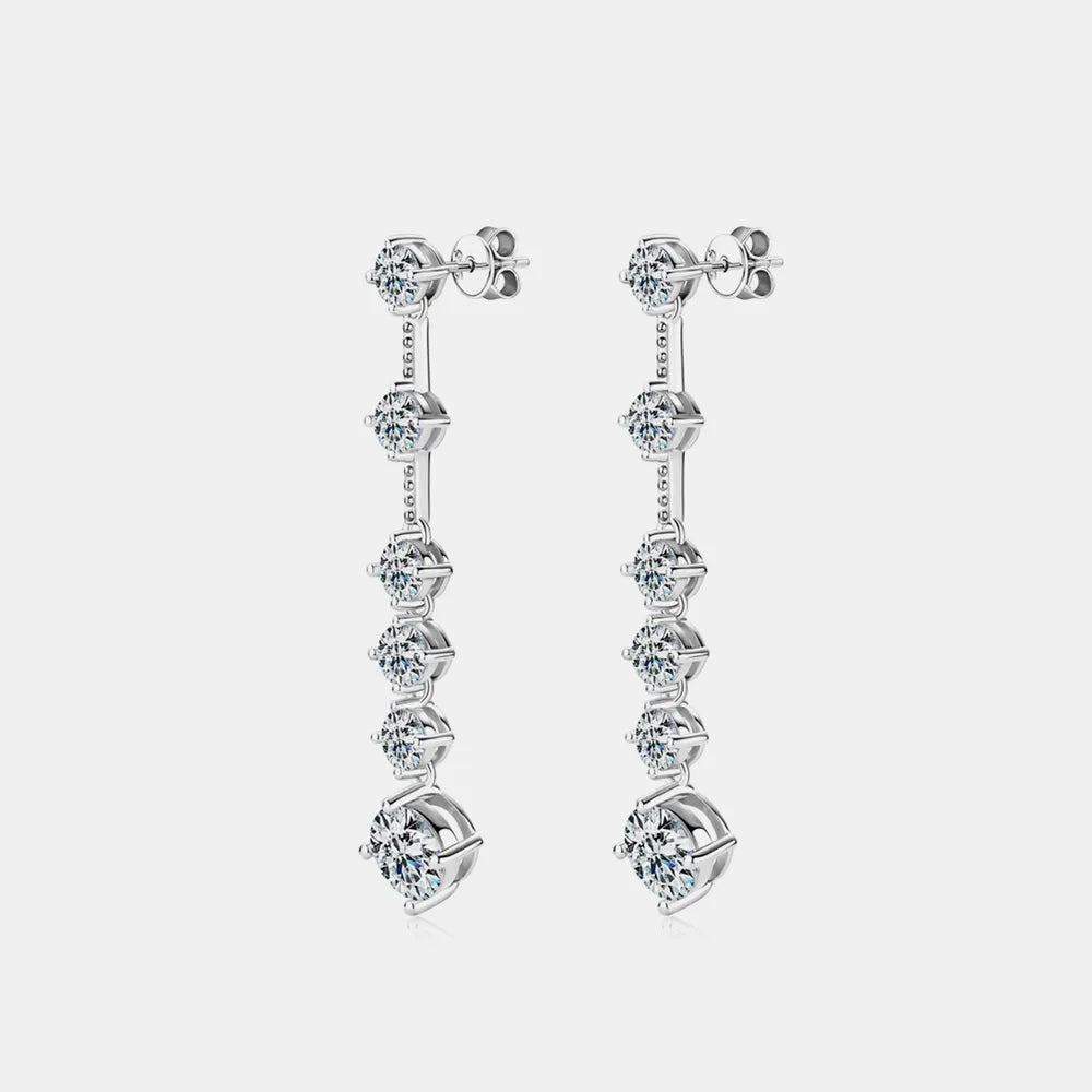 Pair of silver earrings with multiple gemstones on a light gray background