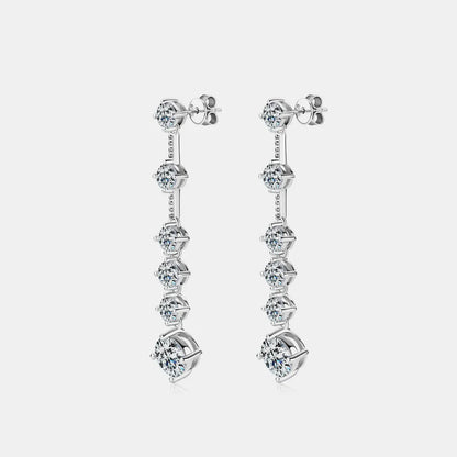 Pair of silver earrings with multiple gemstones on a light gray background