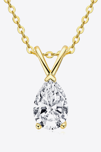 Gold necklace with a teardrop-shaped diamond pendant on a white background