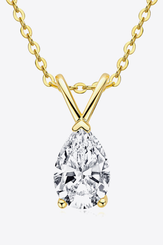 Gold necklace with a teardrop-shaped diamond pendant on a white background