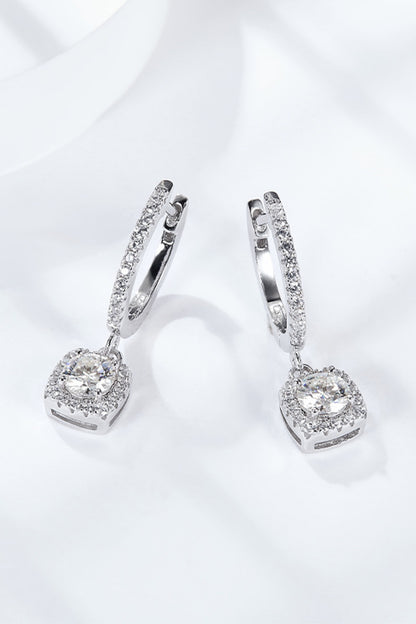 Pair of silver hoop earrings with clear gemstones on a white background