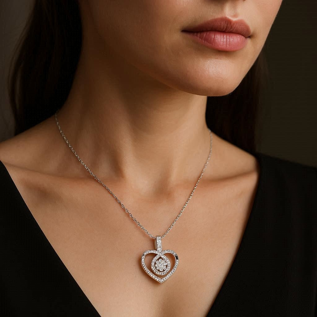 Heart-shaped diamond pendant necklace on a model wearing a black top.