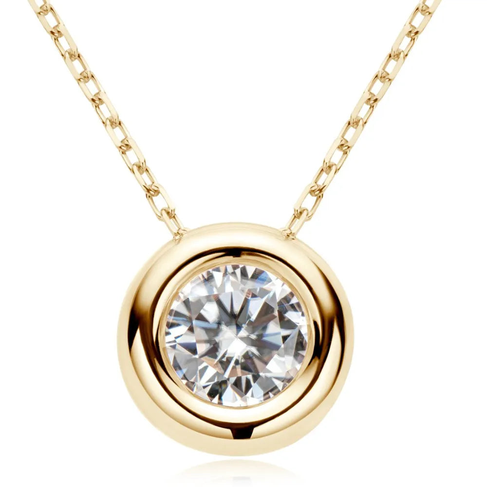 Gold necklace with a round diamond pendant on a white background