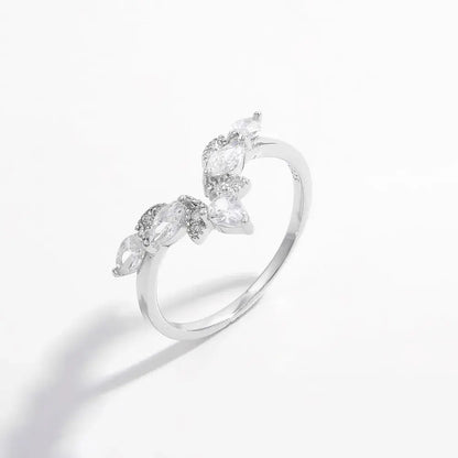 Silver ring with leaf-shaped gemstones on a white background