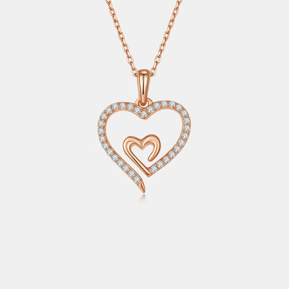 Rose gold heart-shaped necklace with small diamonds on a light gray background