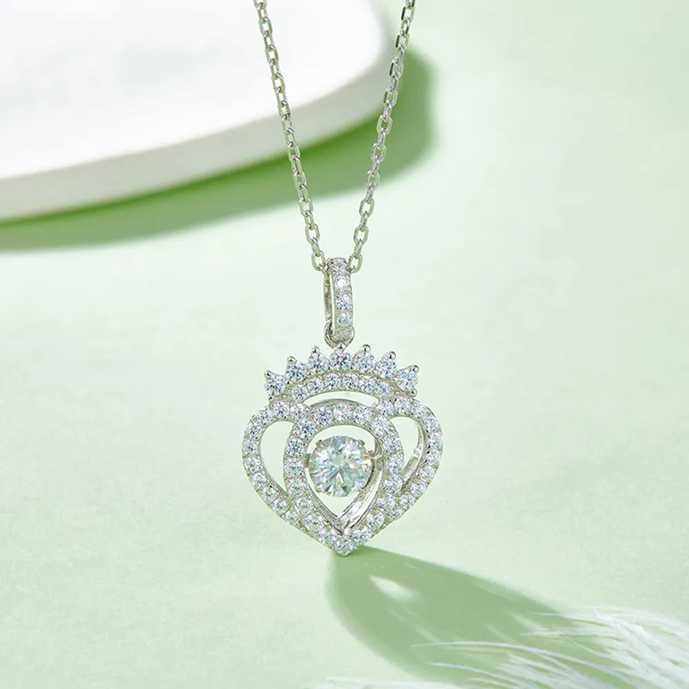 Heart-shaped diamond pendant on a chain against a light green background