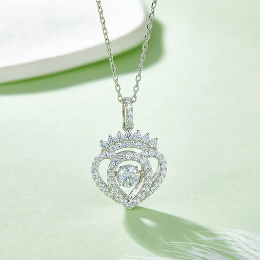Heart-shaped diamond pendant on a chain against a light green background