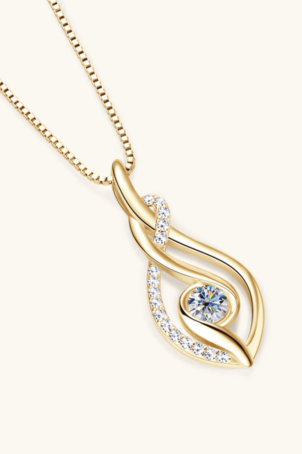 Gold necklace with a heart-shaped pendant on a white background