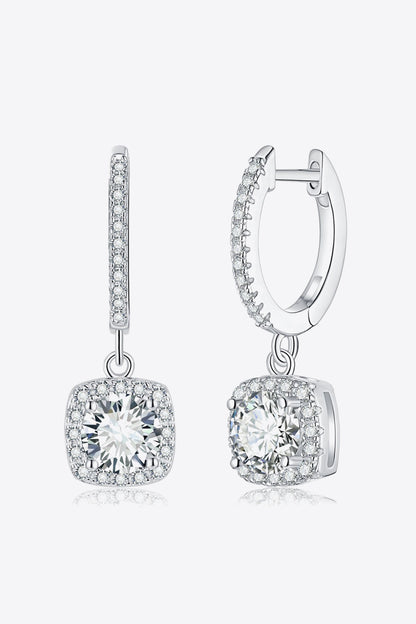 Pair of silver hoop earrings with clear gemstones on a white background
