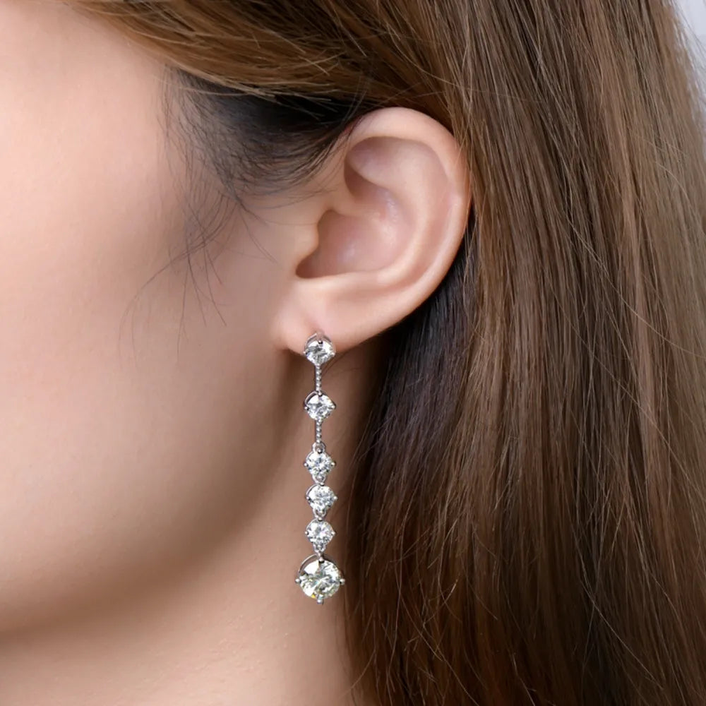 Close-up of a woman wearing a diamond earring with a neutral background