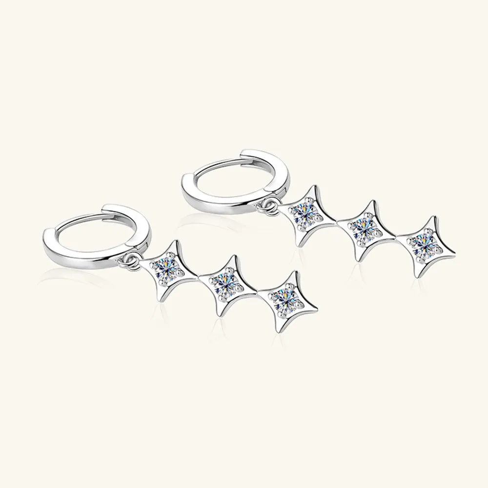 Silver earring with star-shaped dangling elements on a white background