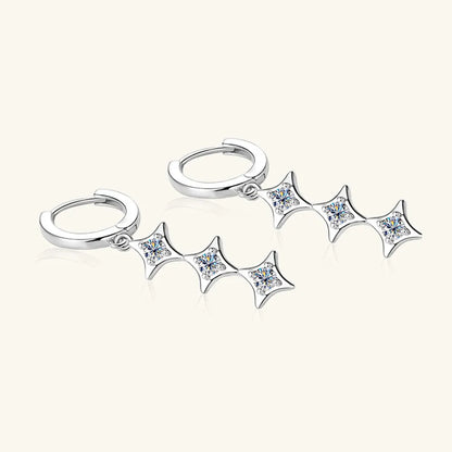 Silver earring with star-shaped dangling elements on a white background