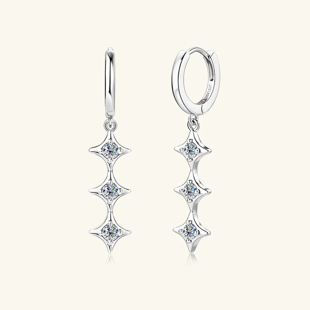 Pair of silver earrings with star-shaped designs on a white background