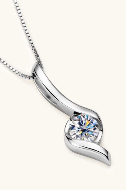 Silver necklace with a heart-shaped diamond pendant on a white background