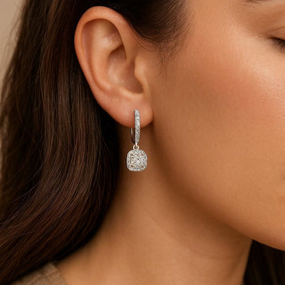 Close-up of a woman wearing a diamond earring.